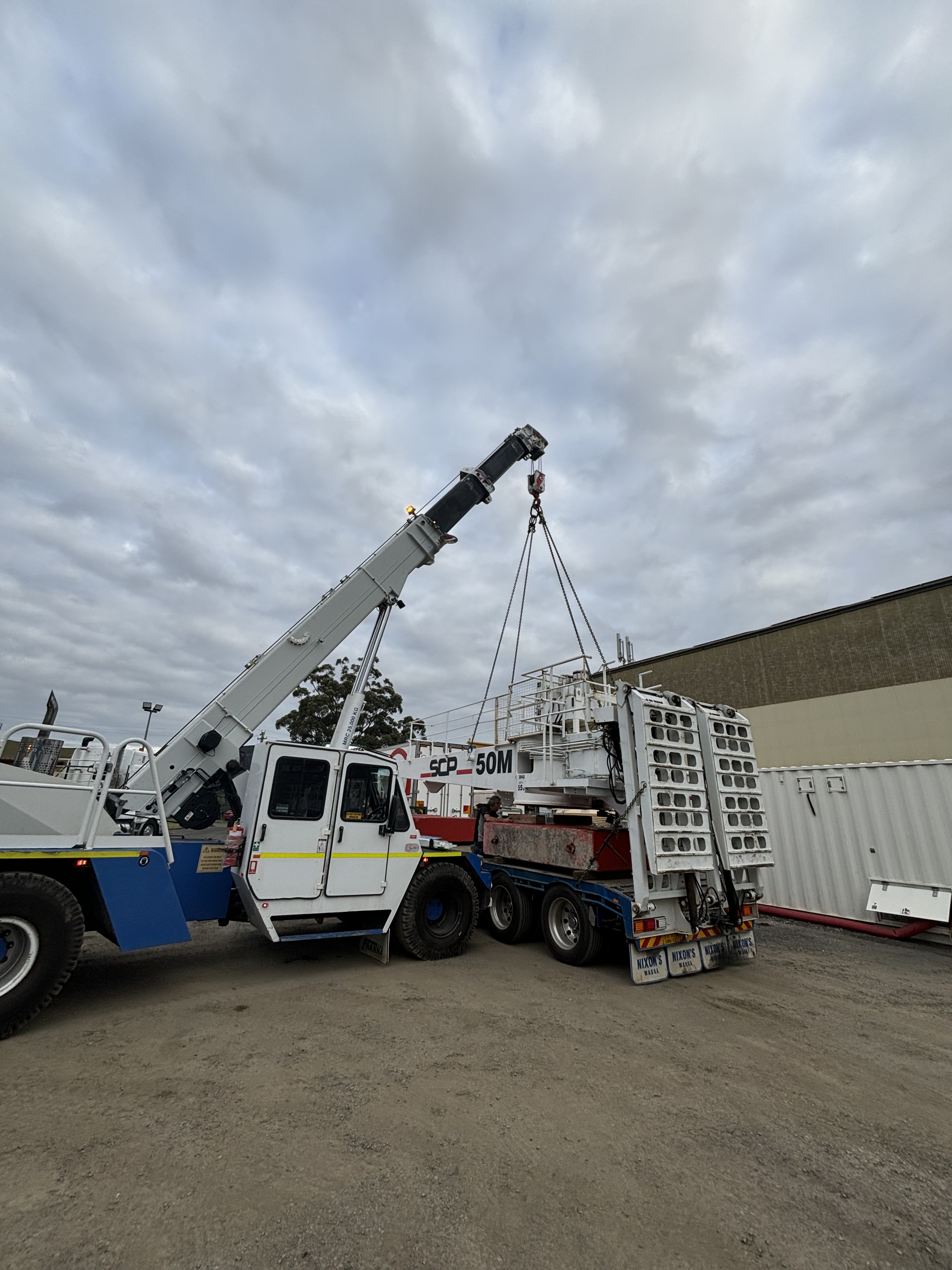 crane lifting onto truck